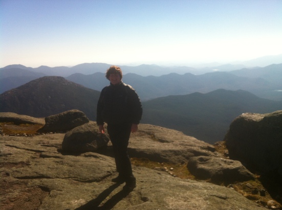 Braving the wind on the 5,344 foot summit of Mt Marcy, highest peak in the Adirondacks